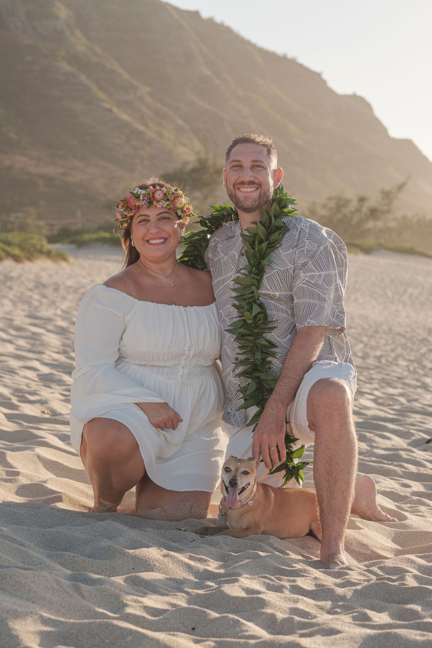 Couple wearing leis during a North Shore Oahu couples photography session at sunset.