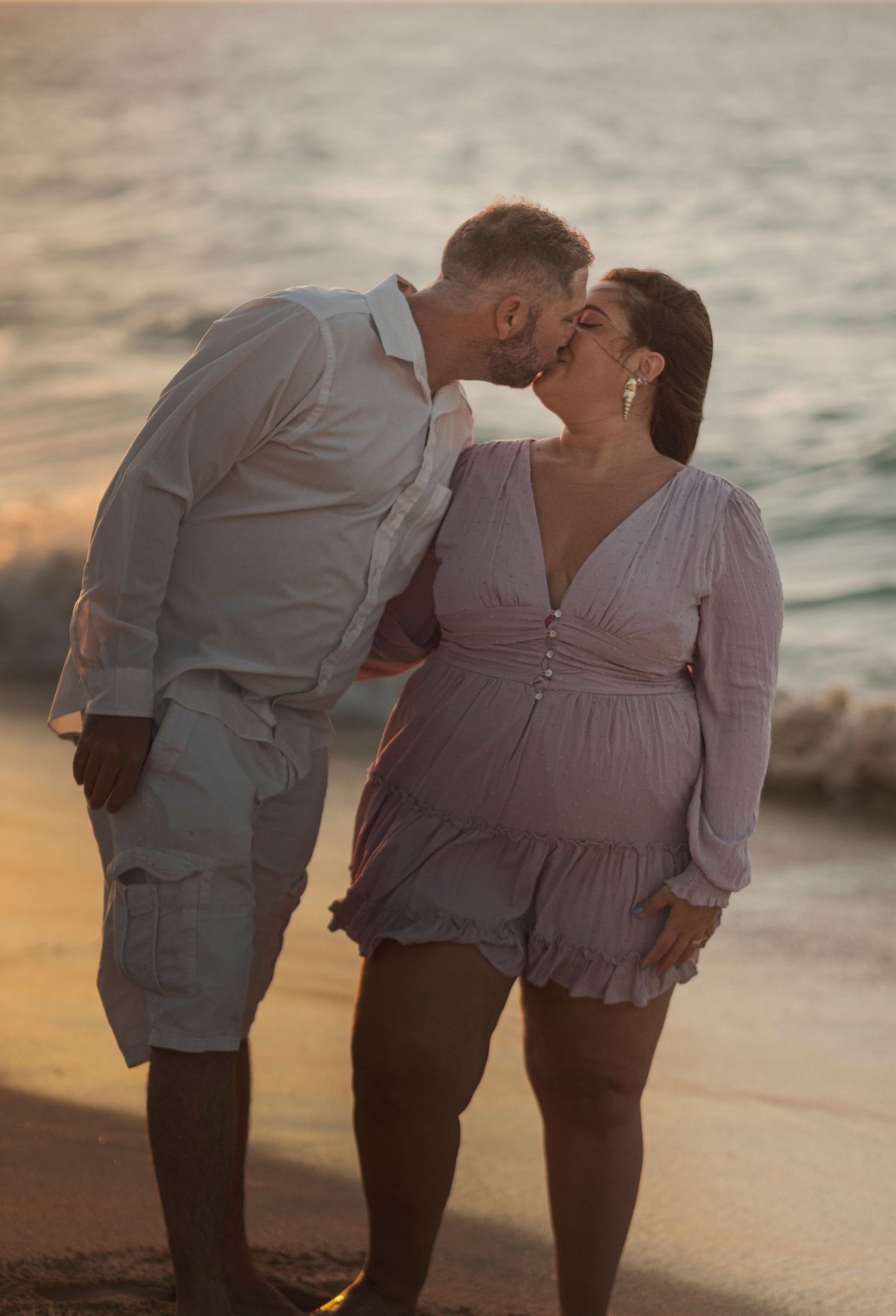 Couple sharing an intimate moment during a North Shore Oahu couples photography session at golden hour.