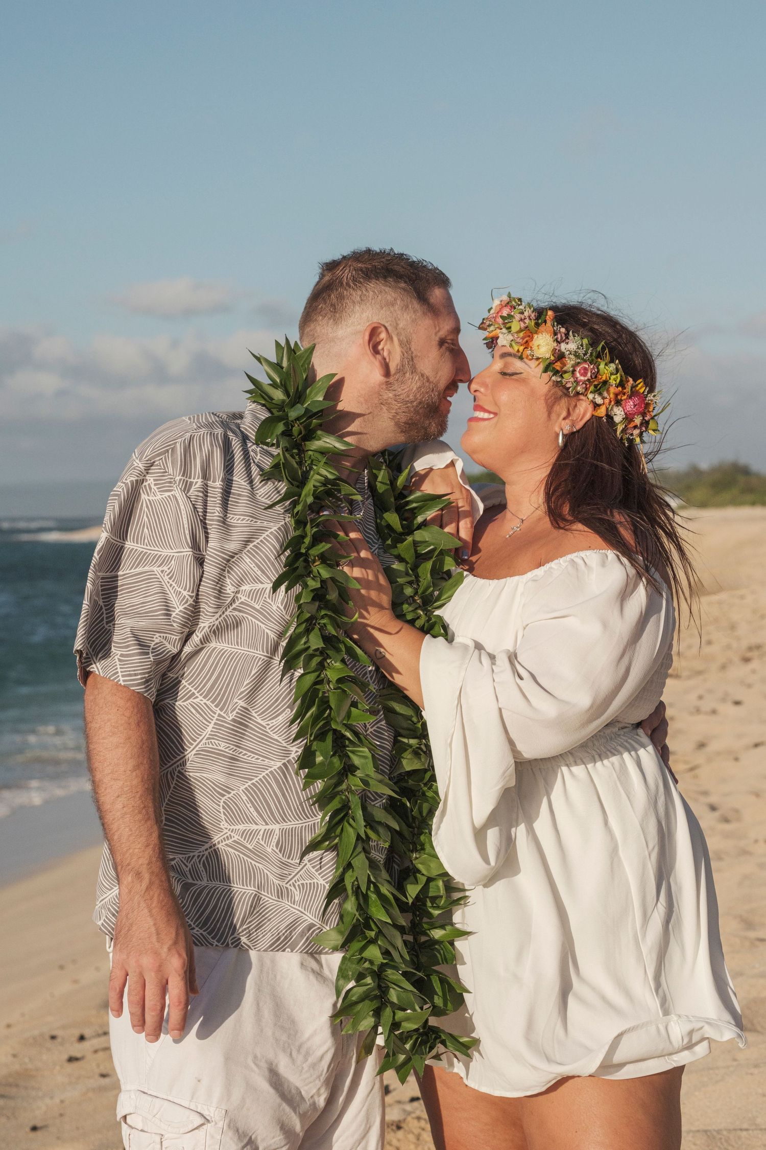 Couple sharing a romantic moment during a North Shore Oahu couples photography session at golden hour.