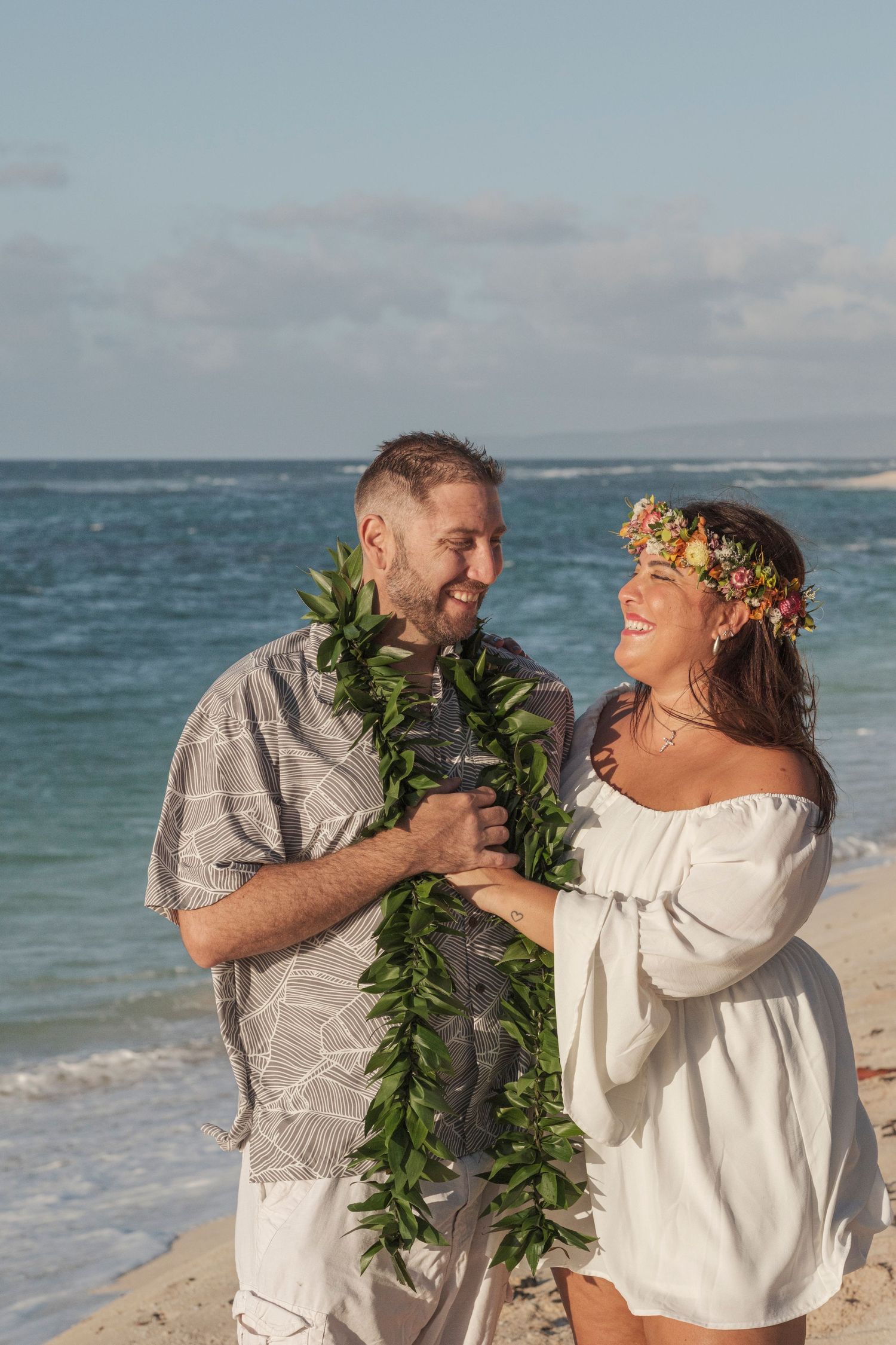 Couple sharing a romantic moment during a North Shore Oahu couples photography session at golden hour.