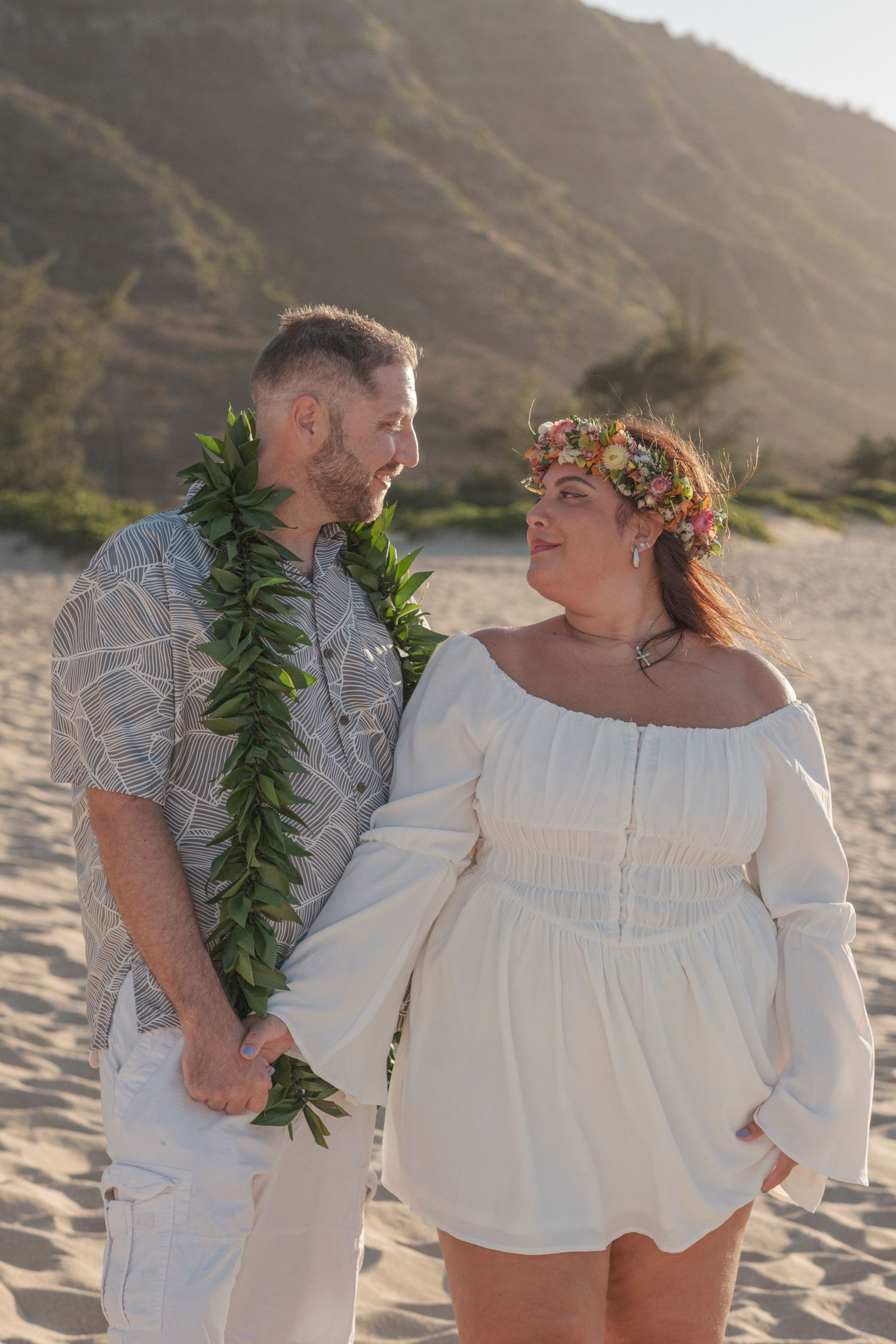 Couple sharing an intimate moment during a North Shore Oahu couples photography session at golden hour.