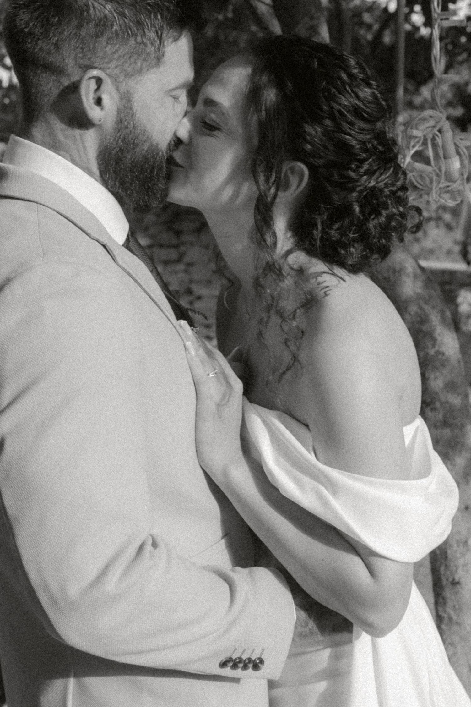 A romantic black and white photo sequence shows a couple in formal attire sharing tender kisses and embraces.