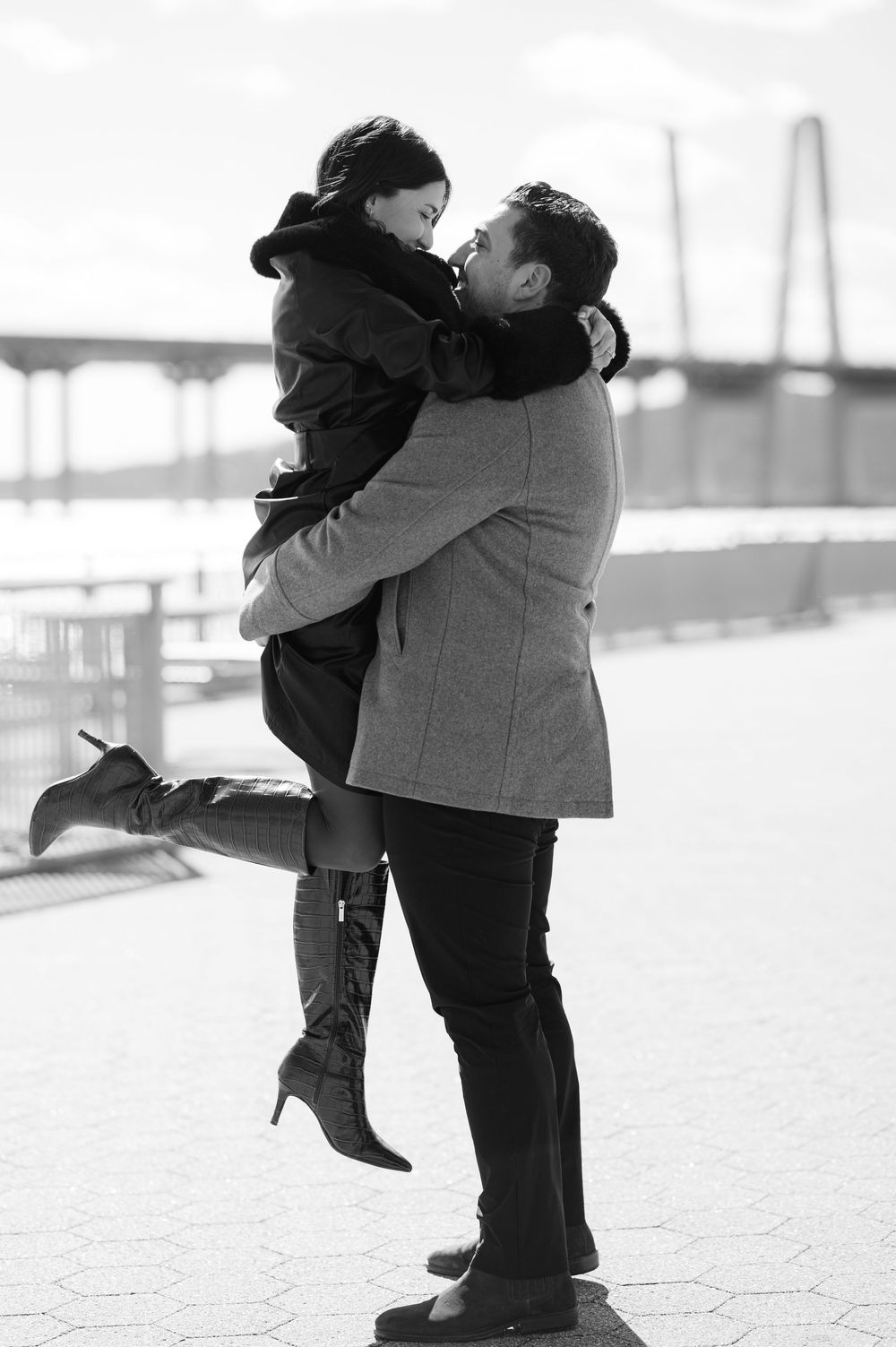 A romantic couple embraces and shares a tender moment in the snow, shown in a black and white photo sequence.
