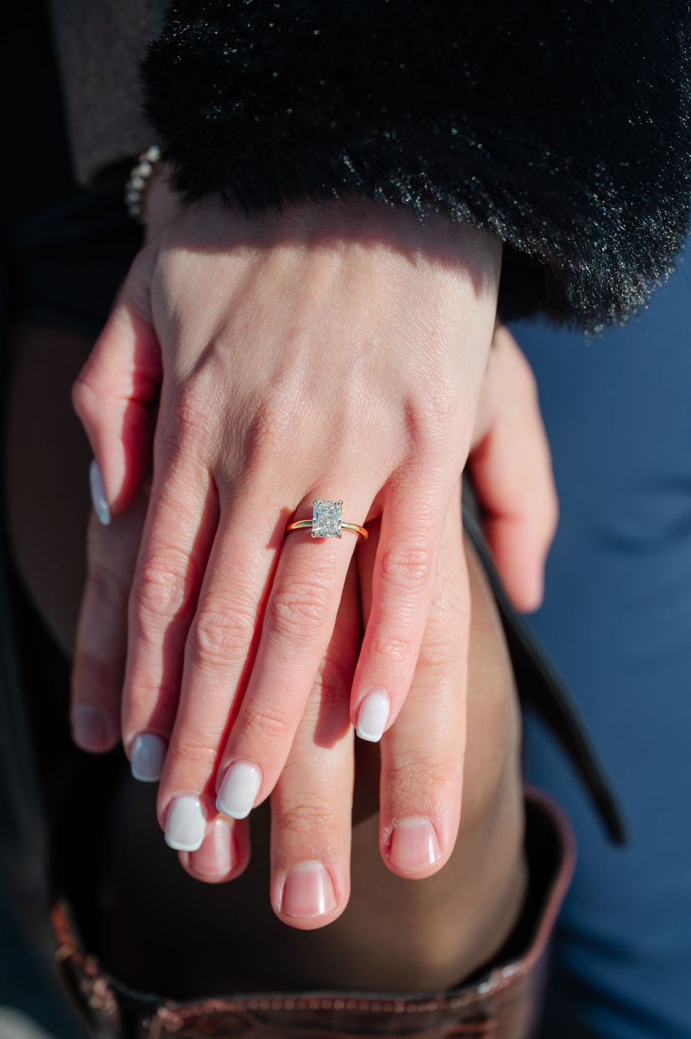 Close-up sequence showing a ring being placed on a finger during an engagement or wedding ceremony.