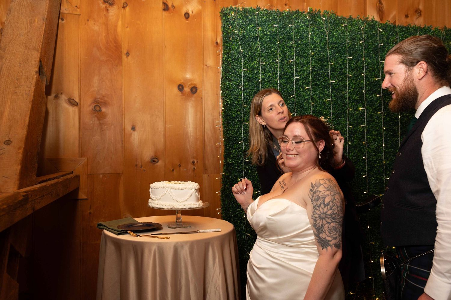 Couple shares a tender moment during their first dance at a rustic barn wedding reception with wooden walls.