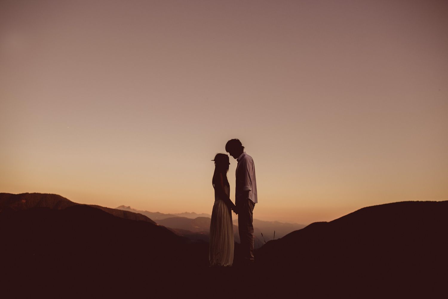Couple silhouette at sunset during intimate Dolomites elopement