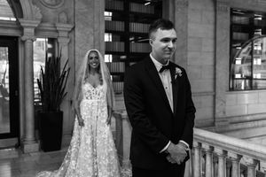 A black and white wedding photo collage showing various candid moments between a couple and guests at an elegant venue.