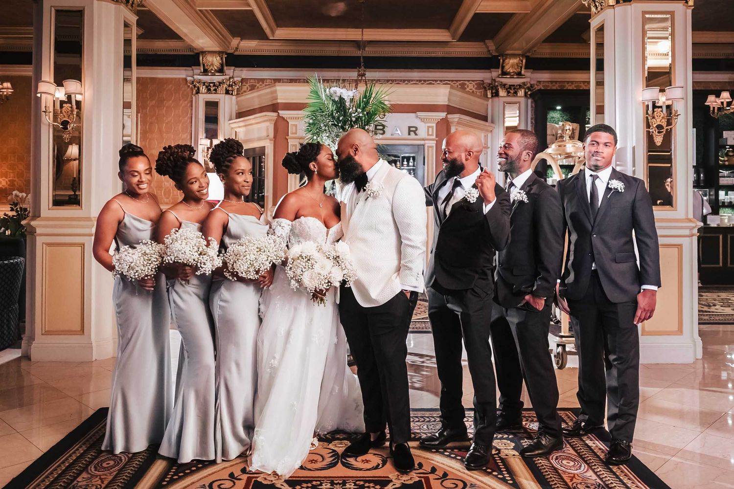 Wedding party portrait in Lenox Hotel Boston lobby with bride and groom and bridesmaids and groomsmen