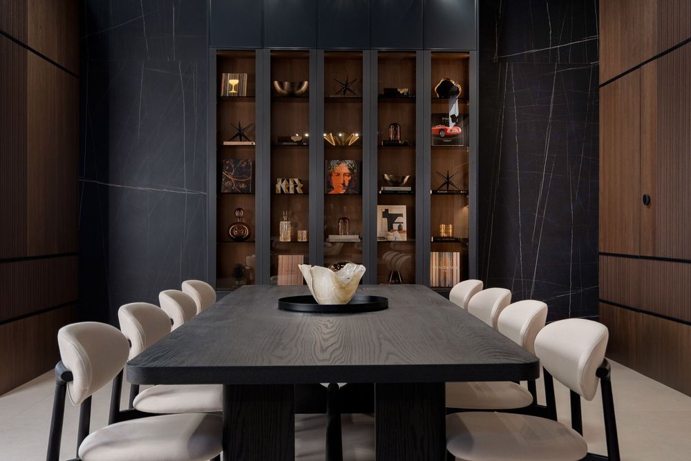 Modern restaurant interior with dark wood paneling, white chairs, and elegant dining tables in minimalist style.