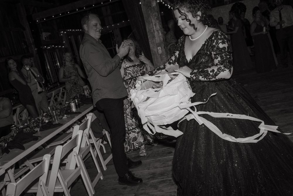 A black and white vintage photograph showing people gathered at what appears to be a social event or celebration.