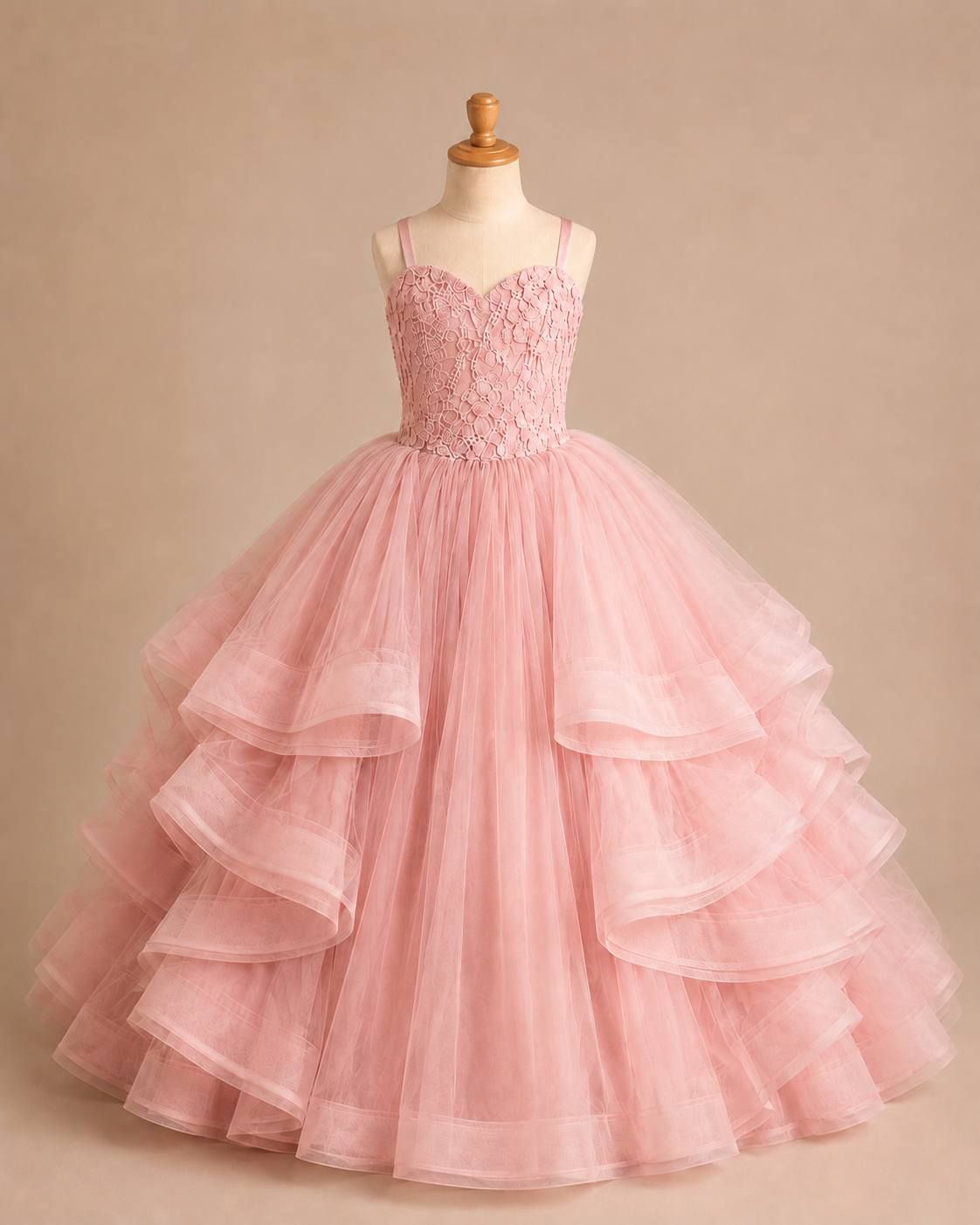 A festive holiday scene with a deep red tulle gown against snow-dusted evergreens and wrapped presents.