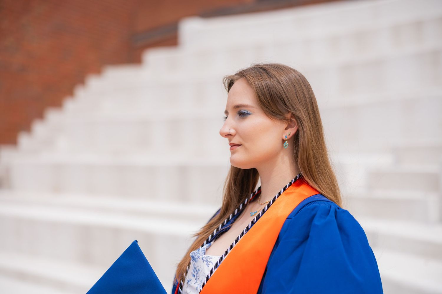 UIUC graduating student thinking about something at the Krannert Center steps