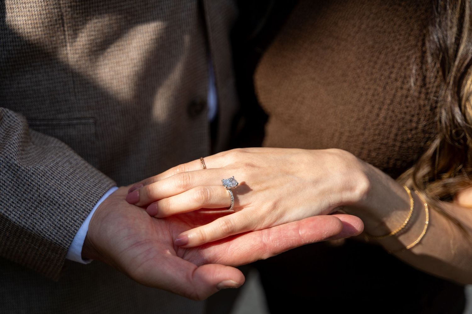 Close-up shots showing hands exchanging a wedding ring during an intimate ceremony.