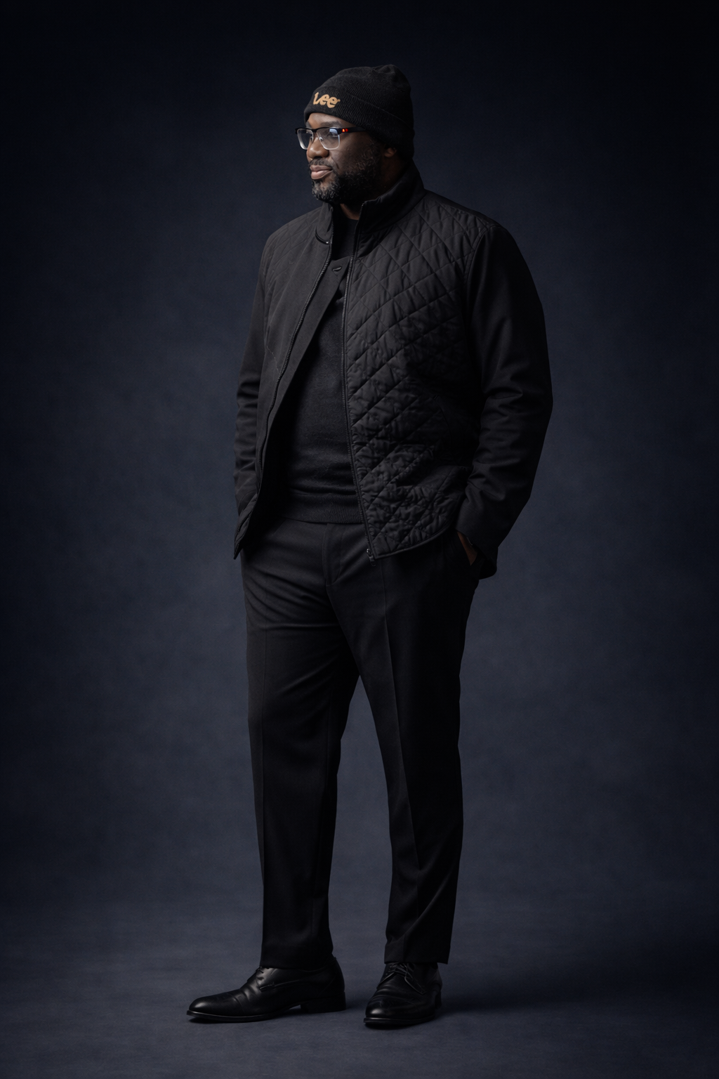 Fashion portrait series showing person in all black clothing against dark background.
