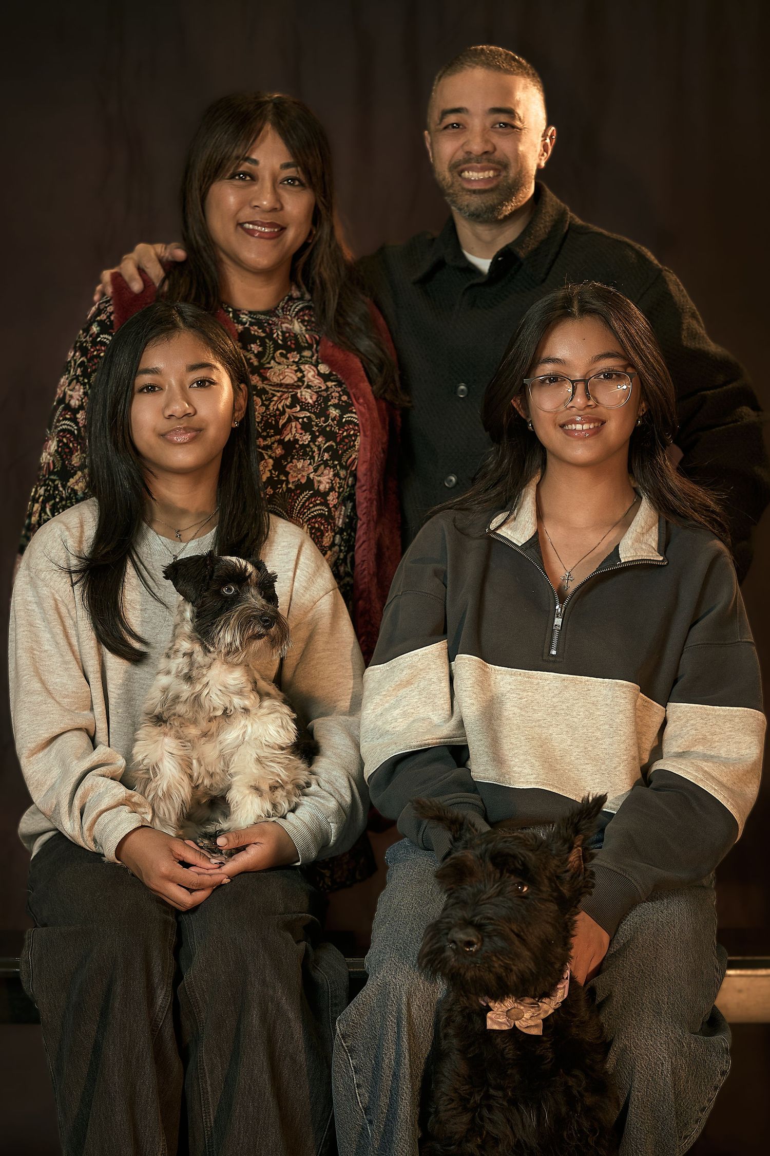 Family sitting together on a wooden bench in an autumn garden setting in at Weston Ranch California.