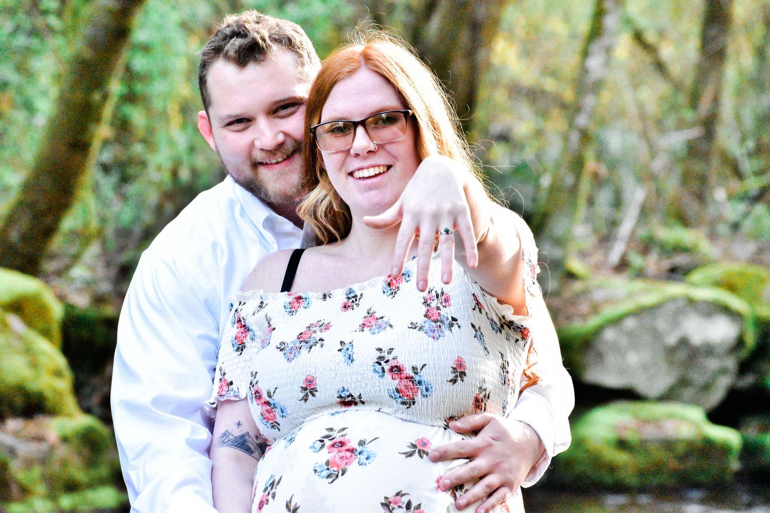 Couple embracing on a wooded trail during a spring engagement session in the Pacific Northwest. Natural light and rustic forest backdrop add