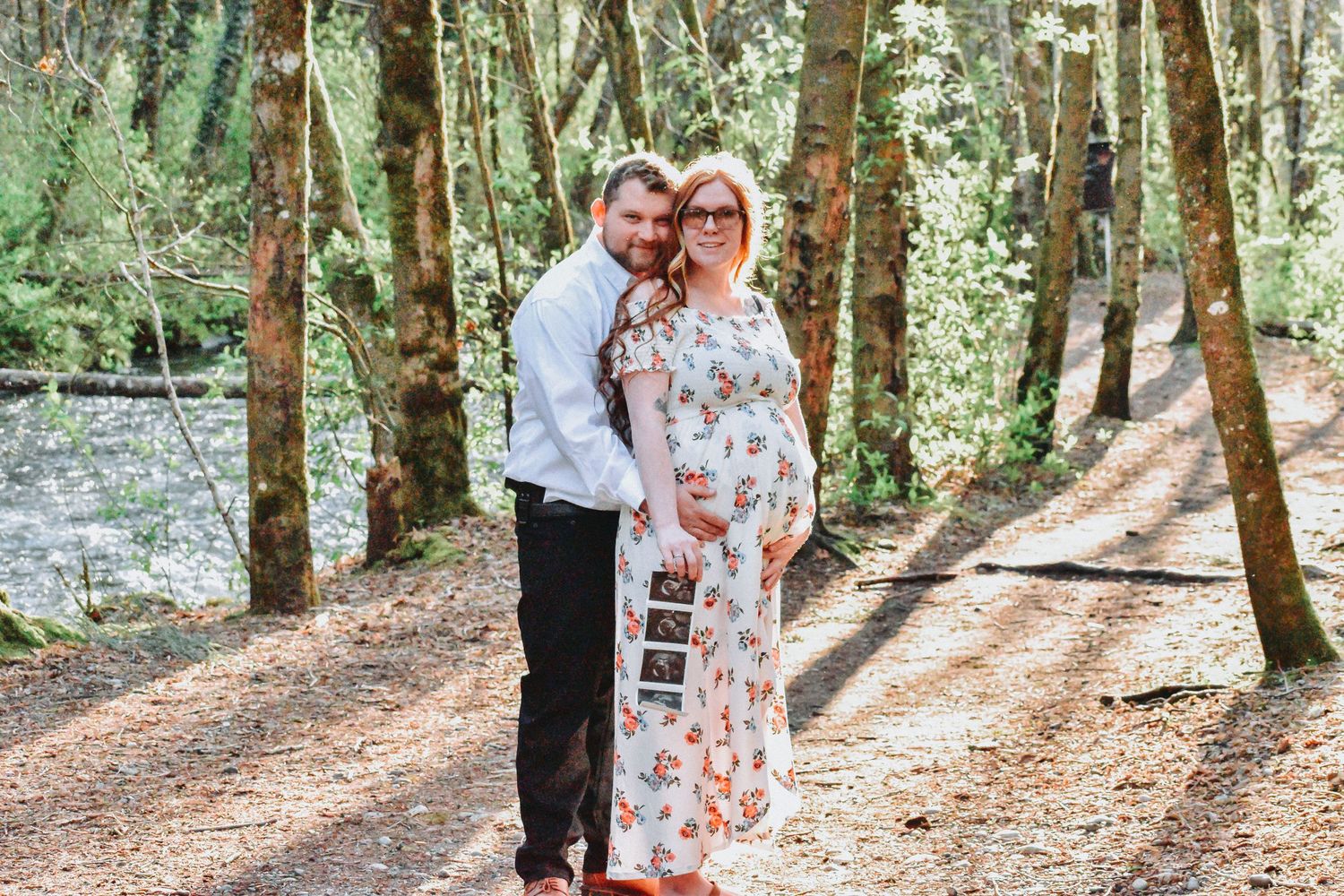 Maternity Portrait in the Woods Tacoma Washington
Maternity photo featuring a smiling couple in a peaceful forest setting with ultrasound