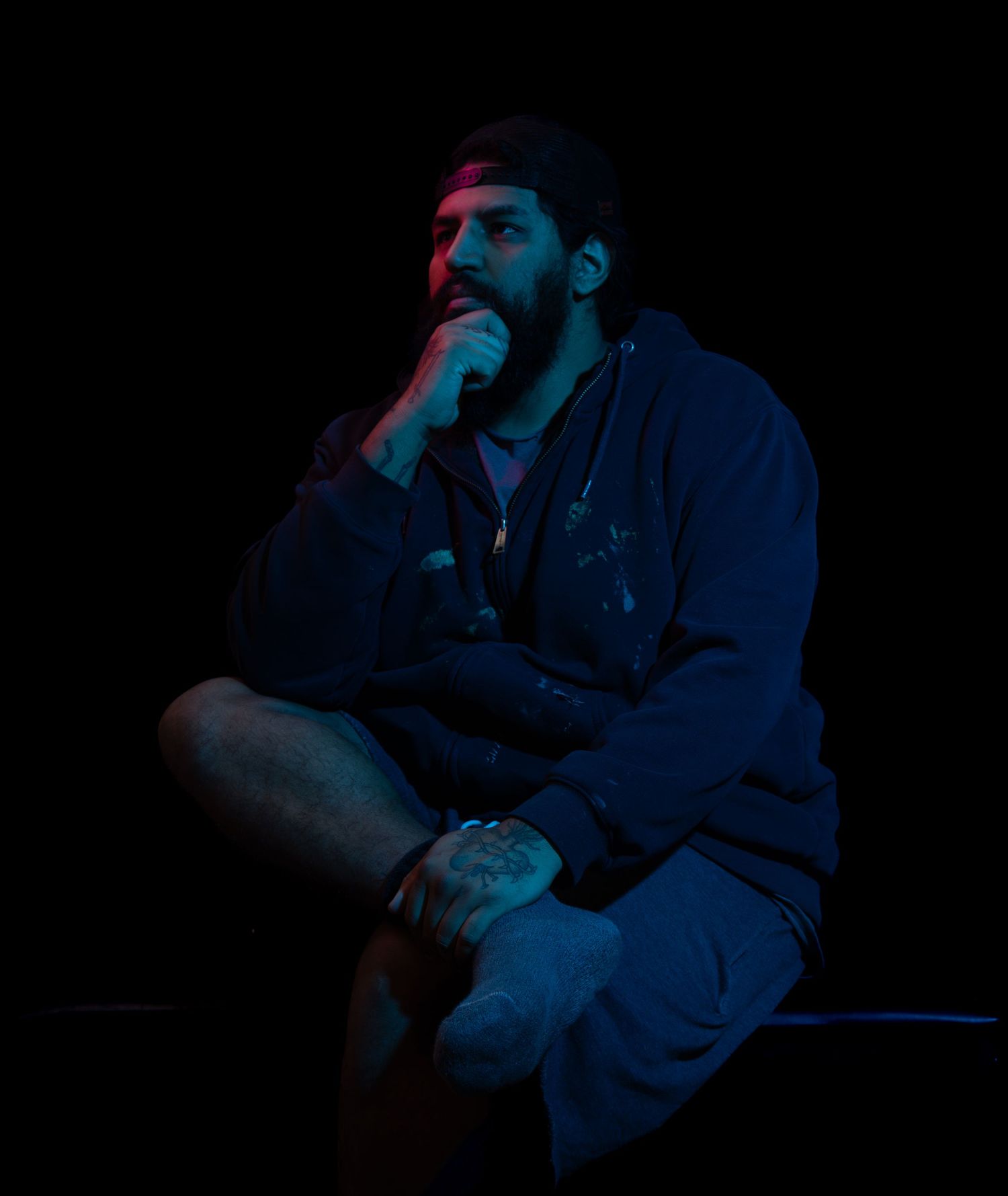 Dark and moody portrait of Ken using mostly blue lighting