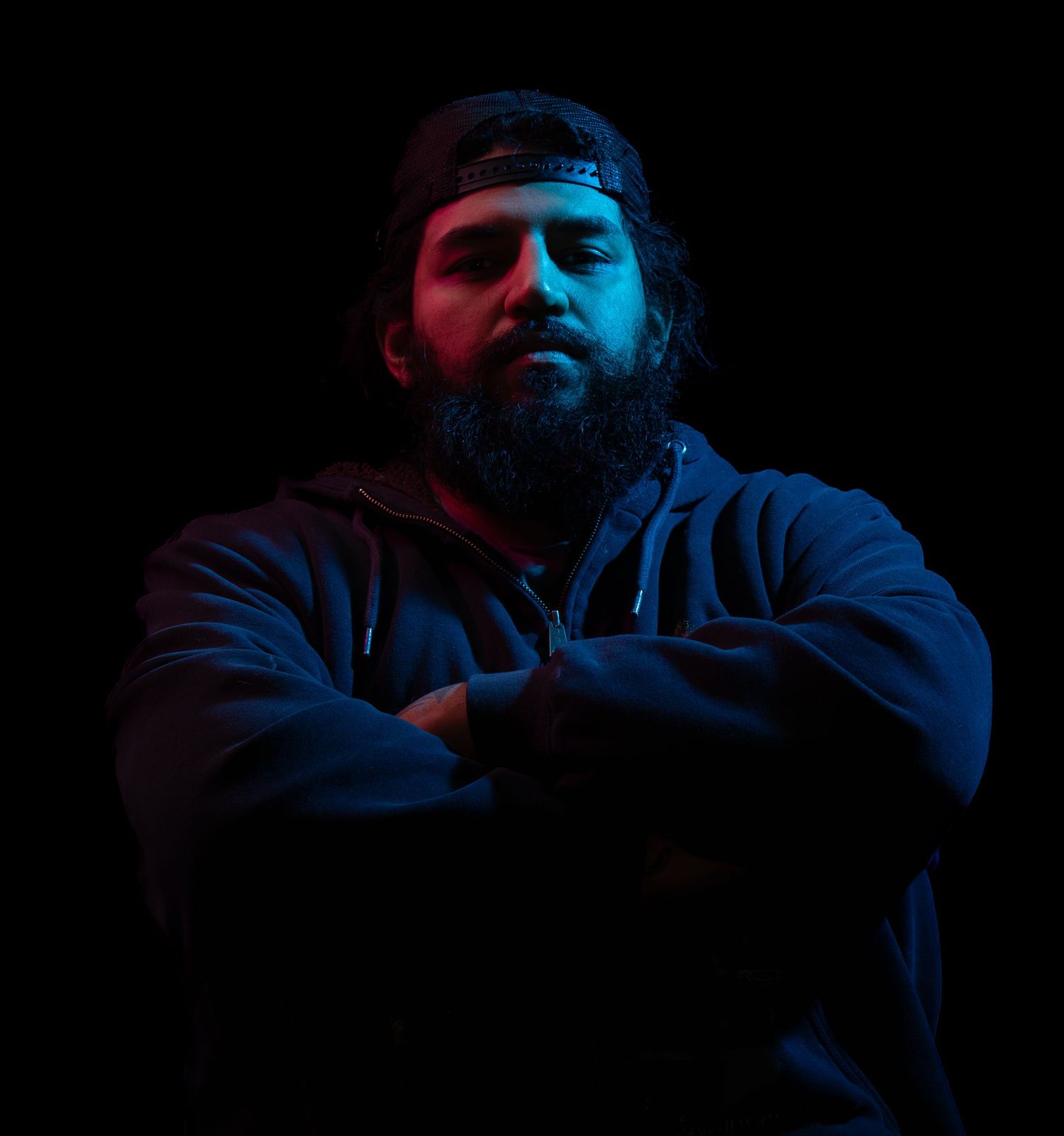 Dark and moody portrait of Ken, using red and blue lights