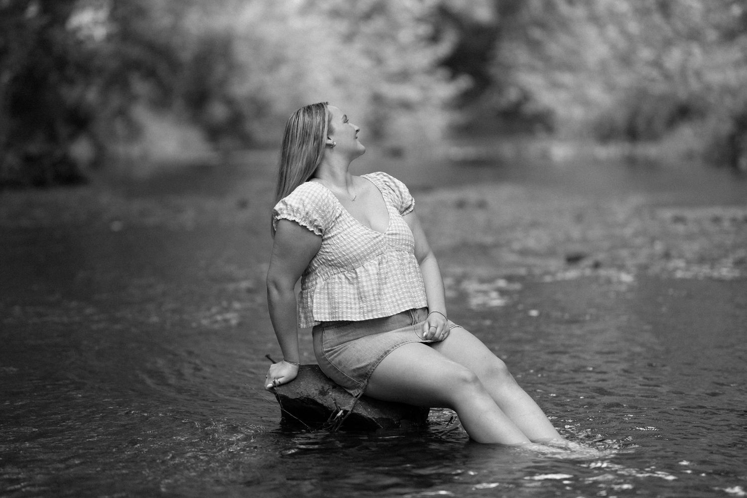 Black and white artistic photos of a figure lying in water creating a dreamy, ethereal effect.