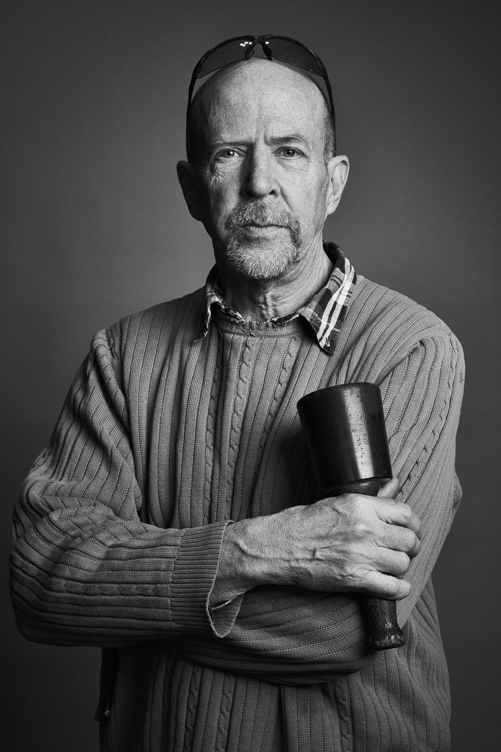 Black and white portrait series showing someone in a sweater holding a smoking pipe in different contemplative poses.