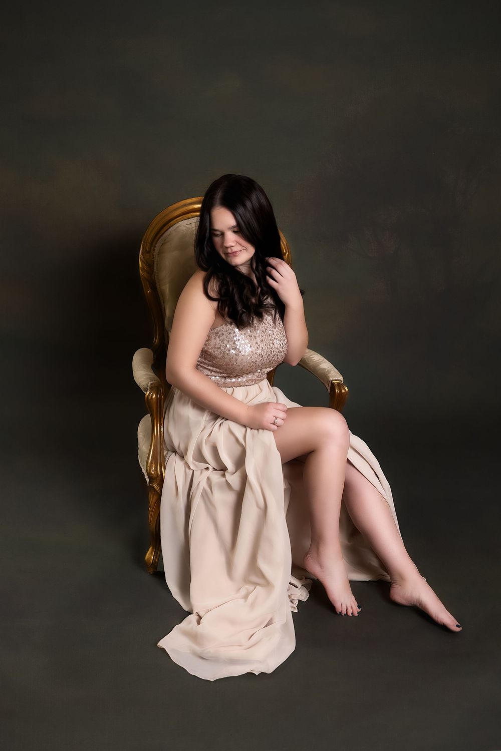 A series of artistic portraits showing a person in a beige dress seated against a dark background in various poses.