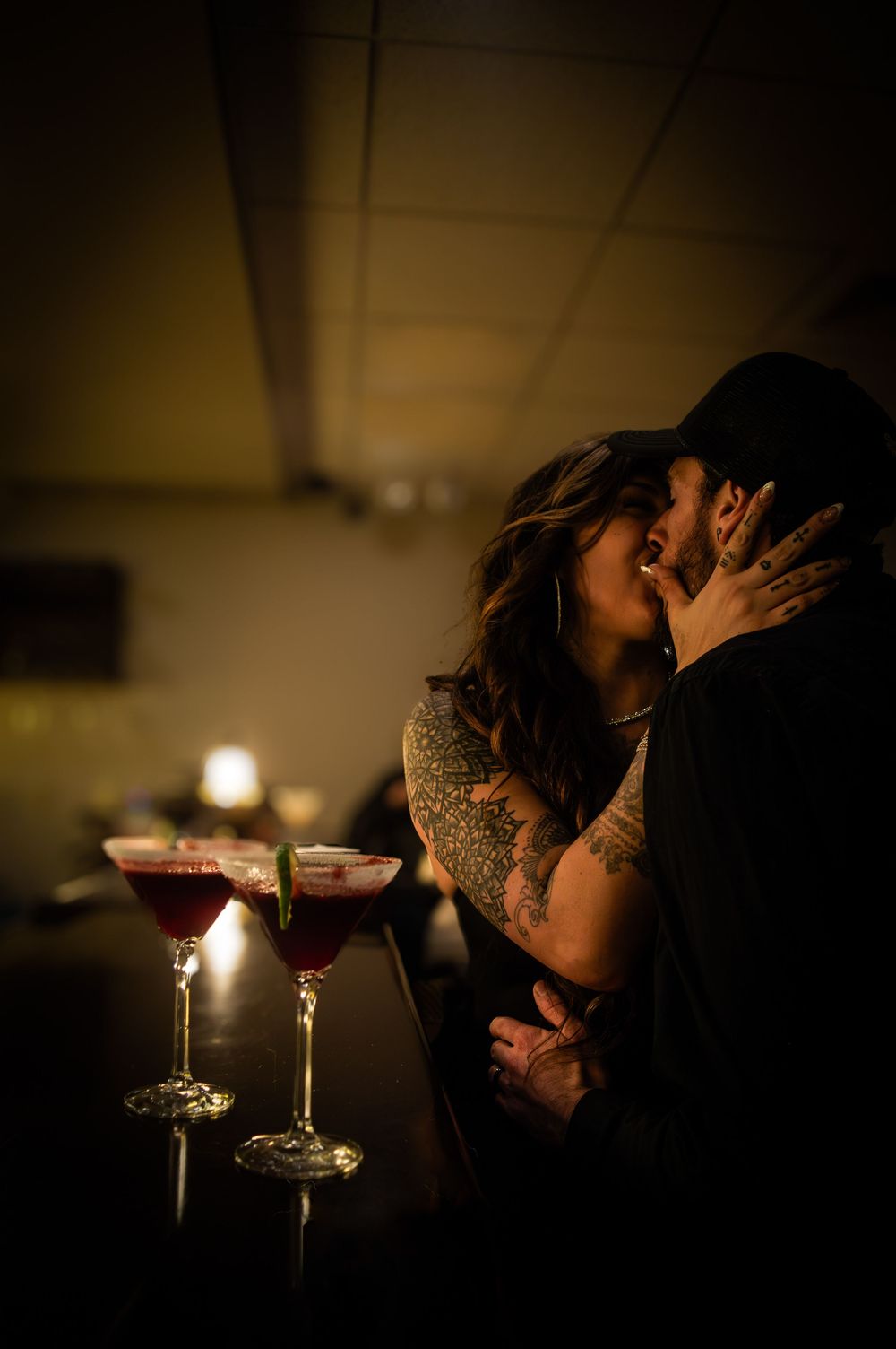 Couple kissing in a bar.