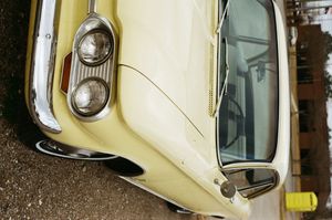 A vintage cream-colored Ford Corvair photographed from multiple angles in an outdoor setting.