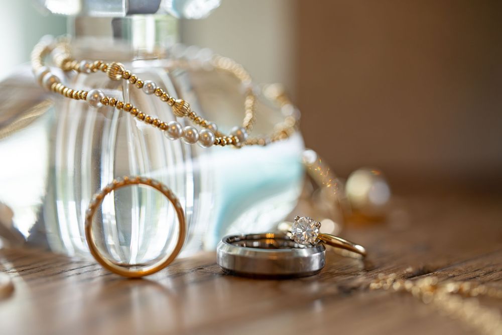 Close-up of gold wedding bands and rings with delicate details.