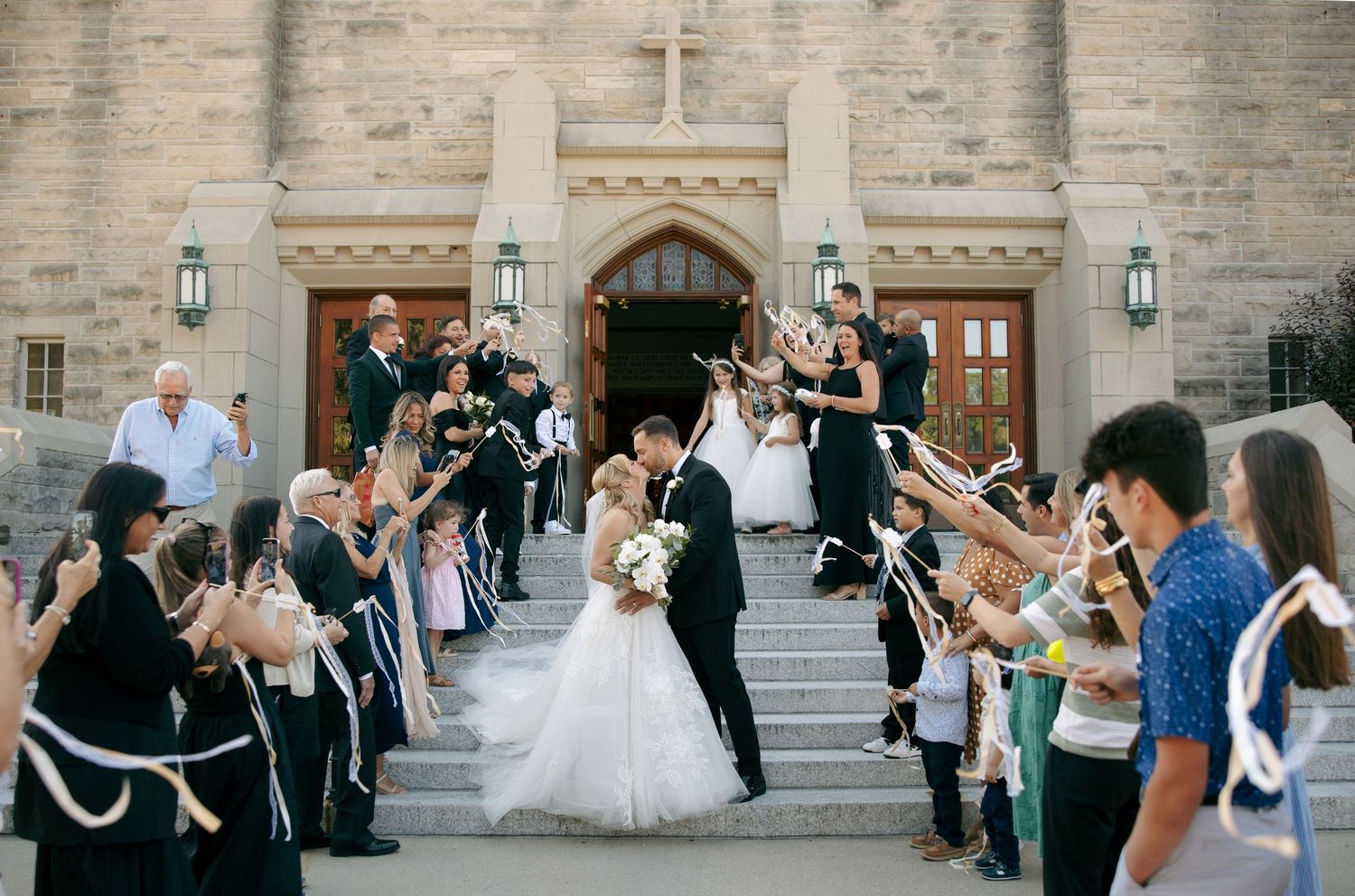 White wedding dress flowing dramatically against stone steps in outdoor setting.