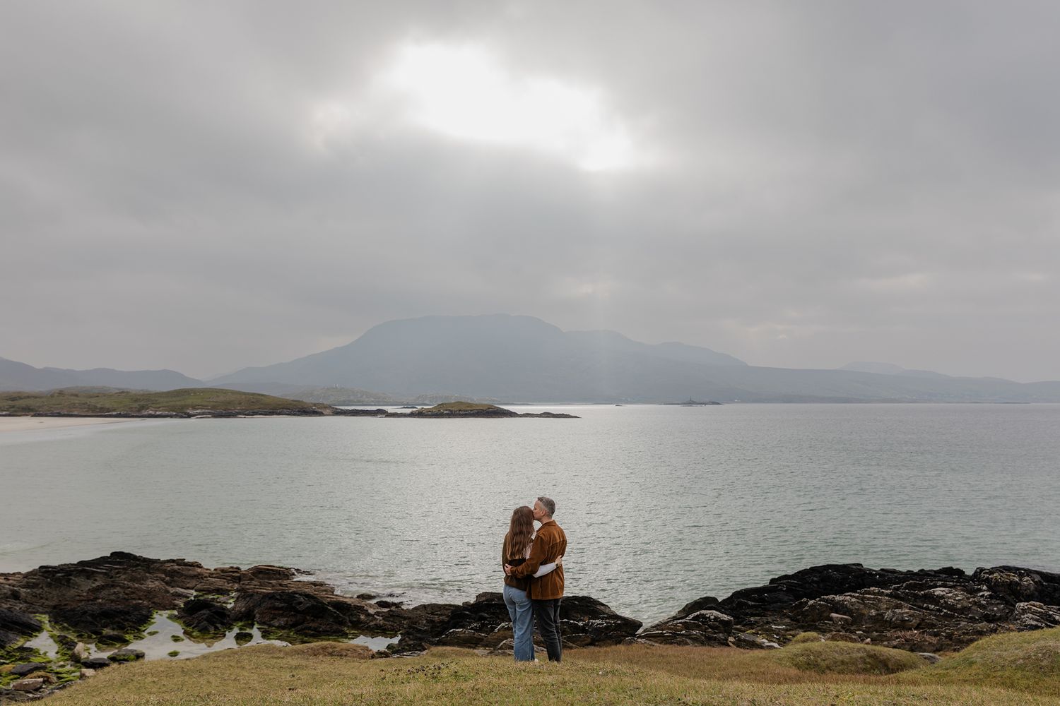 couple embracing each other on silver strand beach during adventure couple session