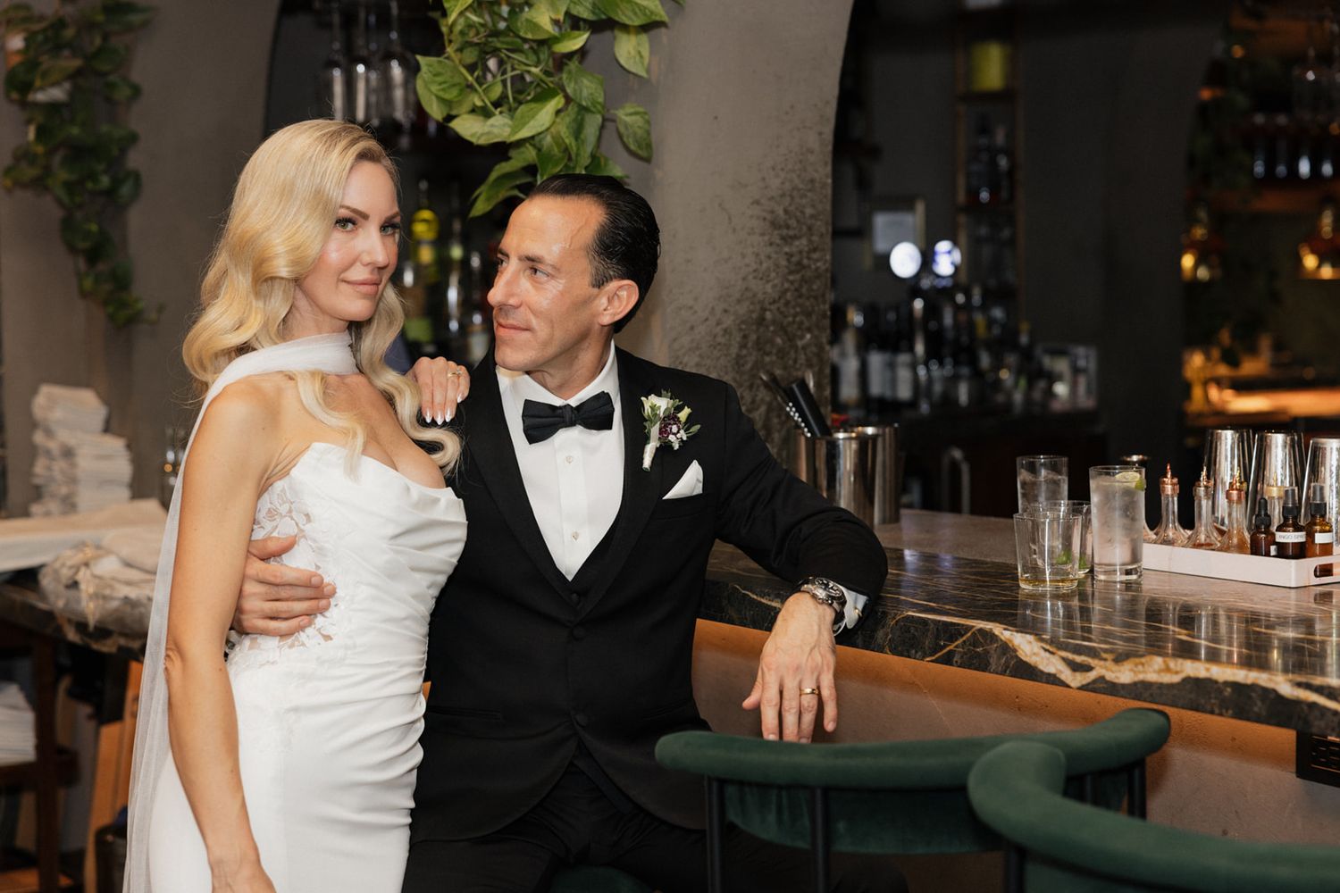 A couple in formal wedding attire share intimate moments across multiple candid shots at their reception celebration.