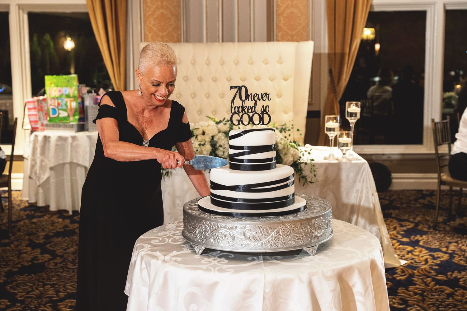 A person's hands reach through delicate white tulle fabric creating an ethereal artistic effect.