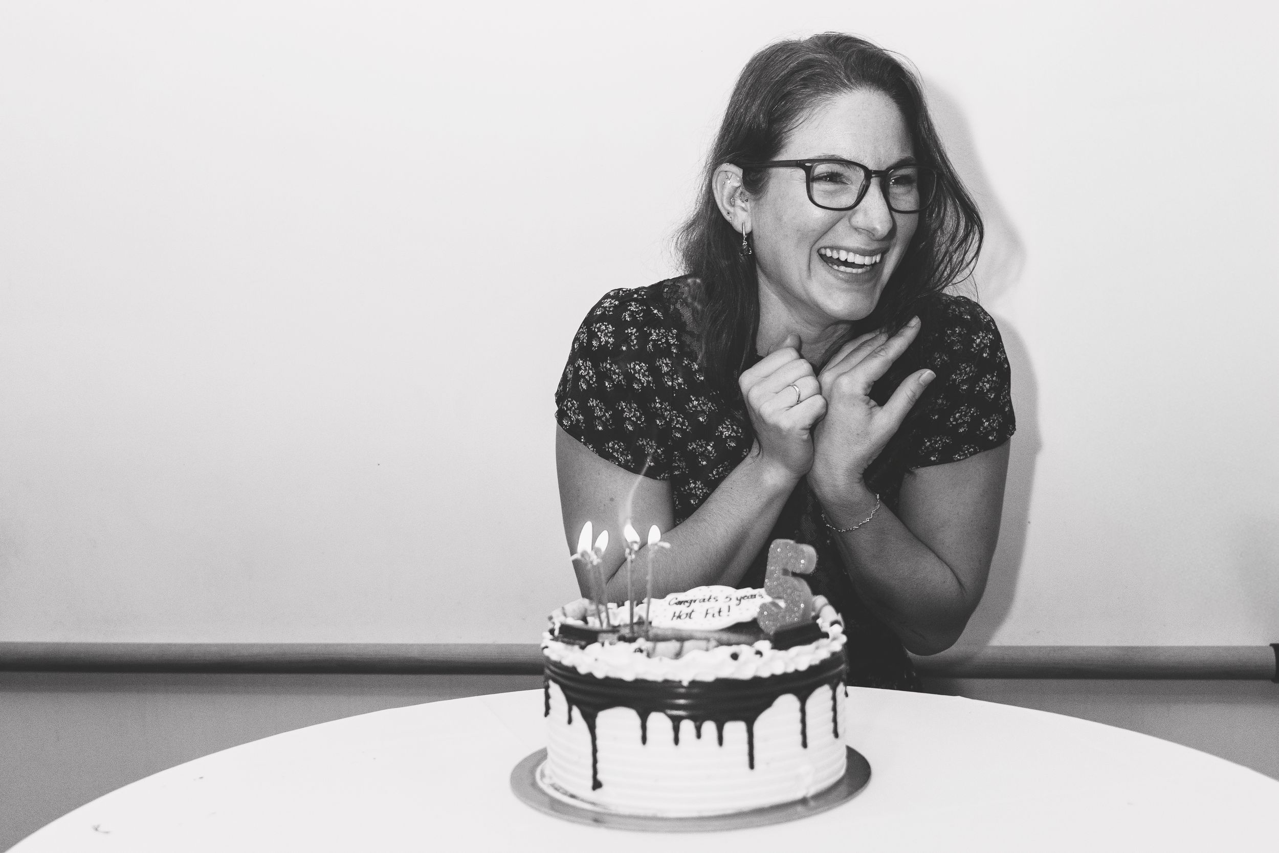 Black and white photo series featuring a birthday celebration with cake and laughter.