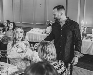 Black and white photos capture candid laughter during wedding reception.