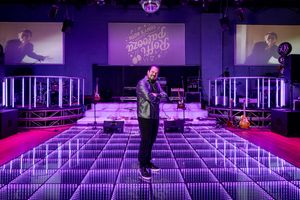LED dance floor glows purple during wedding reception setup.