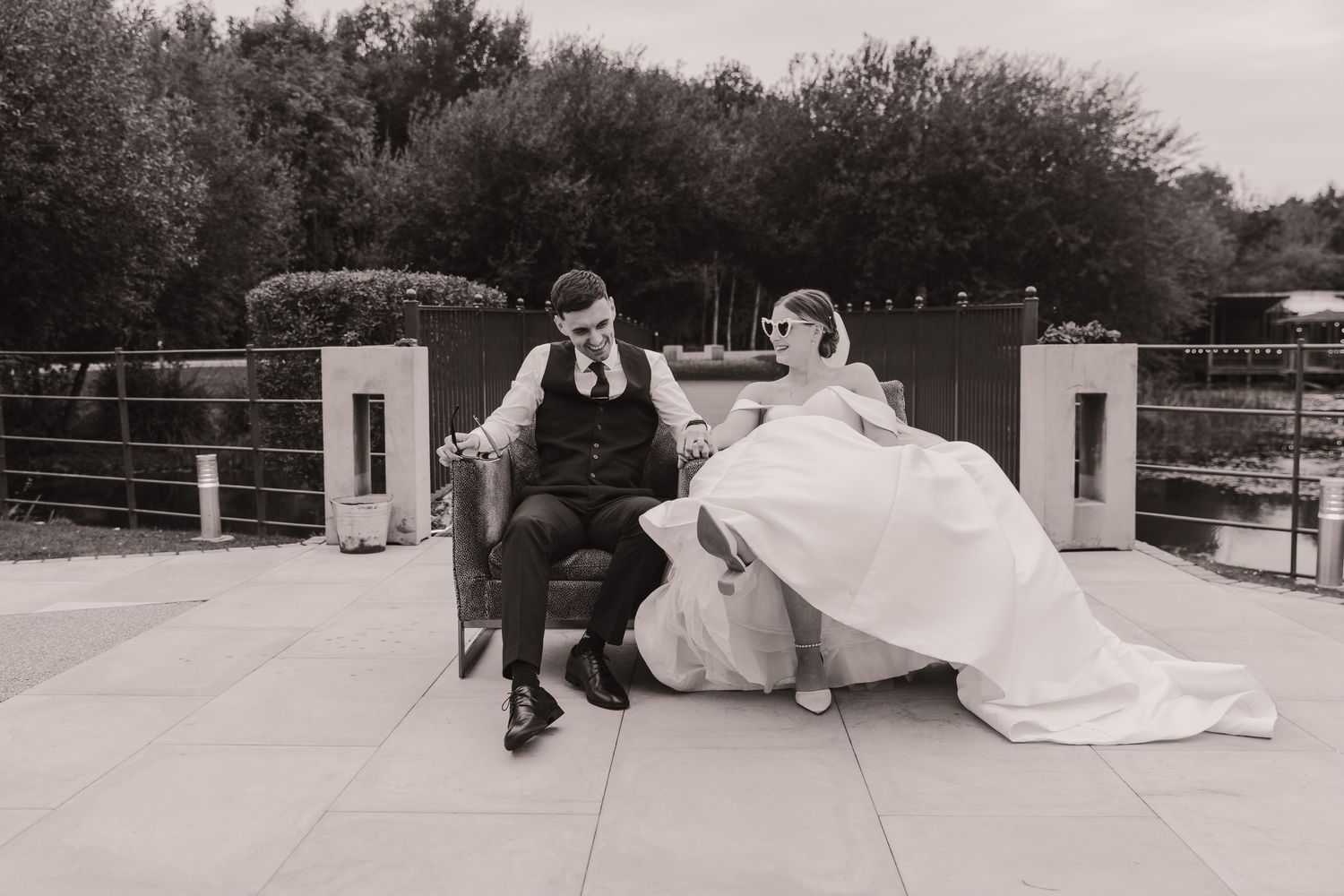 Minimalist black and white wedding photos captured on an outdoor concrete terrace.