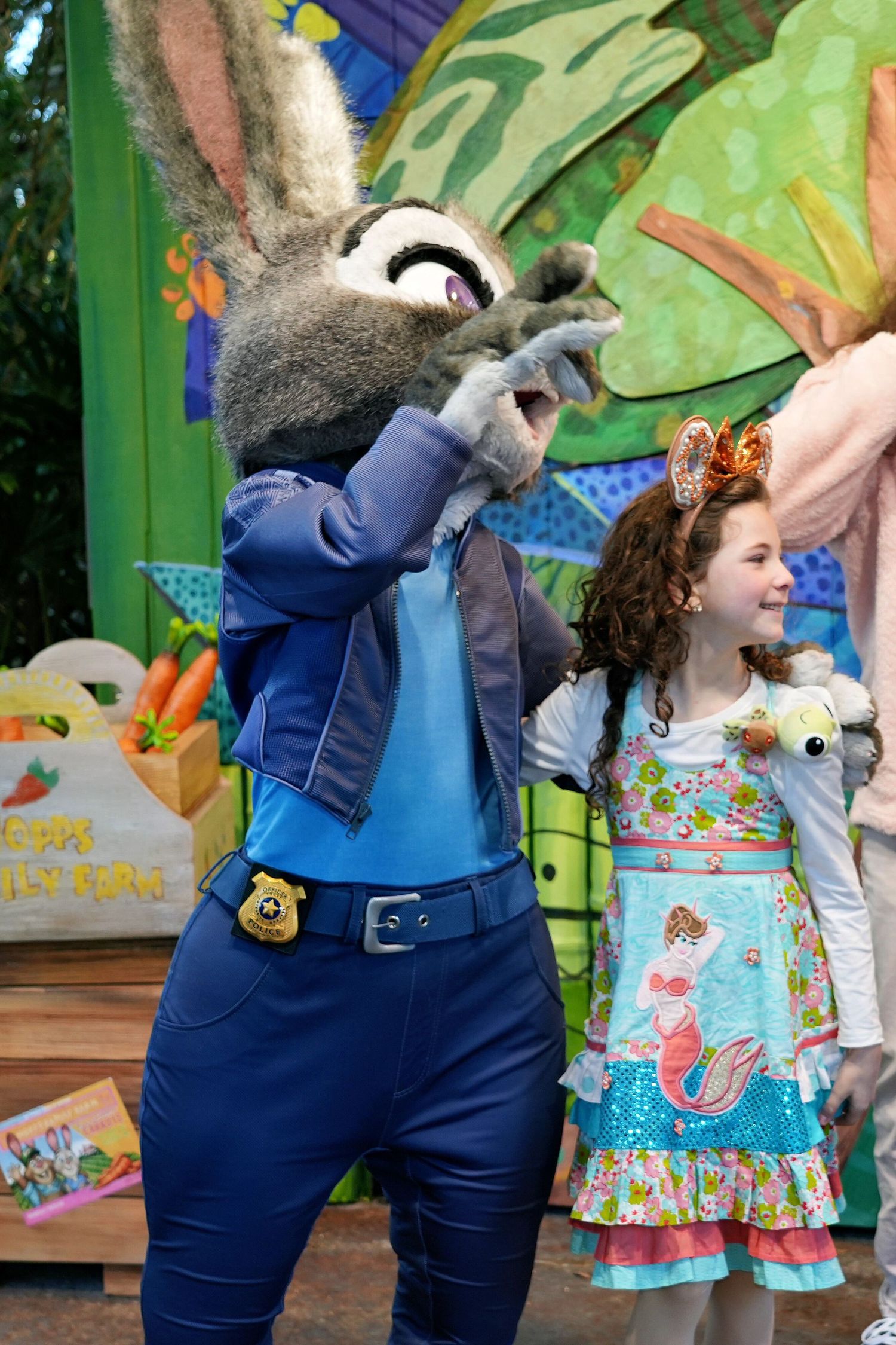 A sequence of dance moves showing someone in blue denim overalls performing the dab motion against a colorful backdrop.