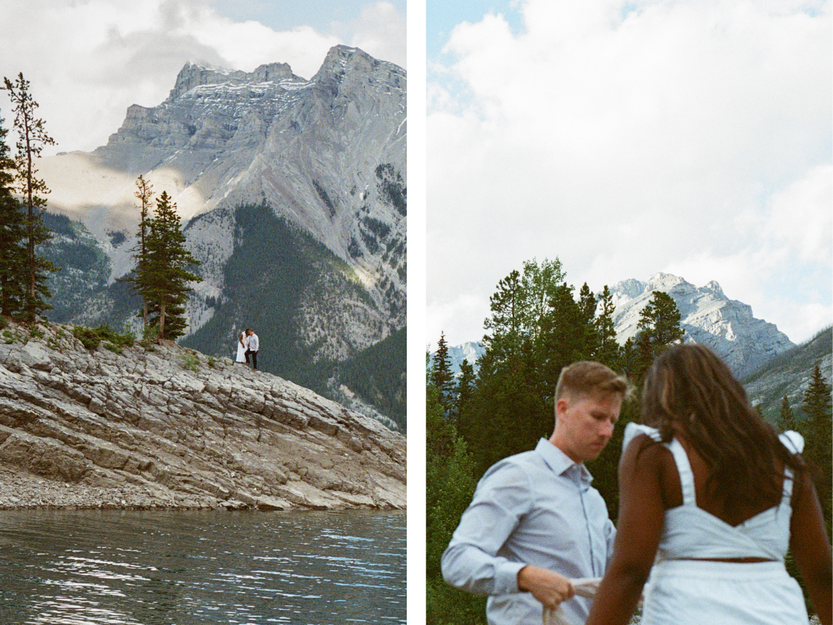 35 mm film photo of bride and groom exploring a rocky outcrop in Lake Minnewanka in Banff with mountains all around them