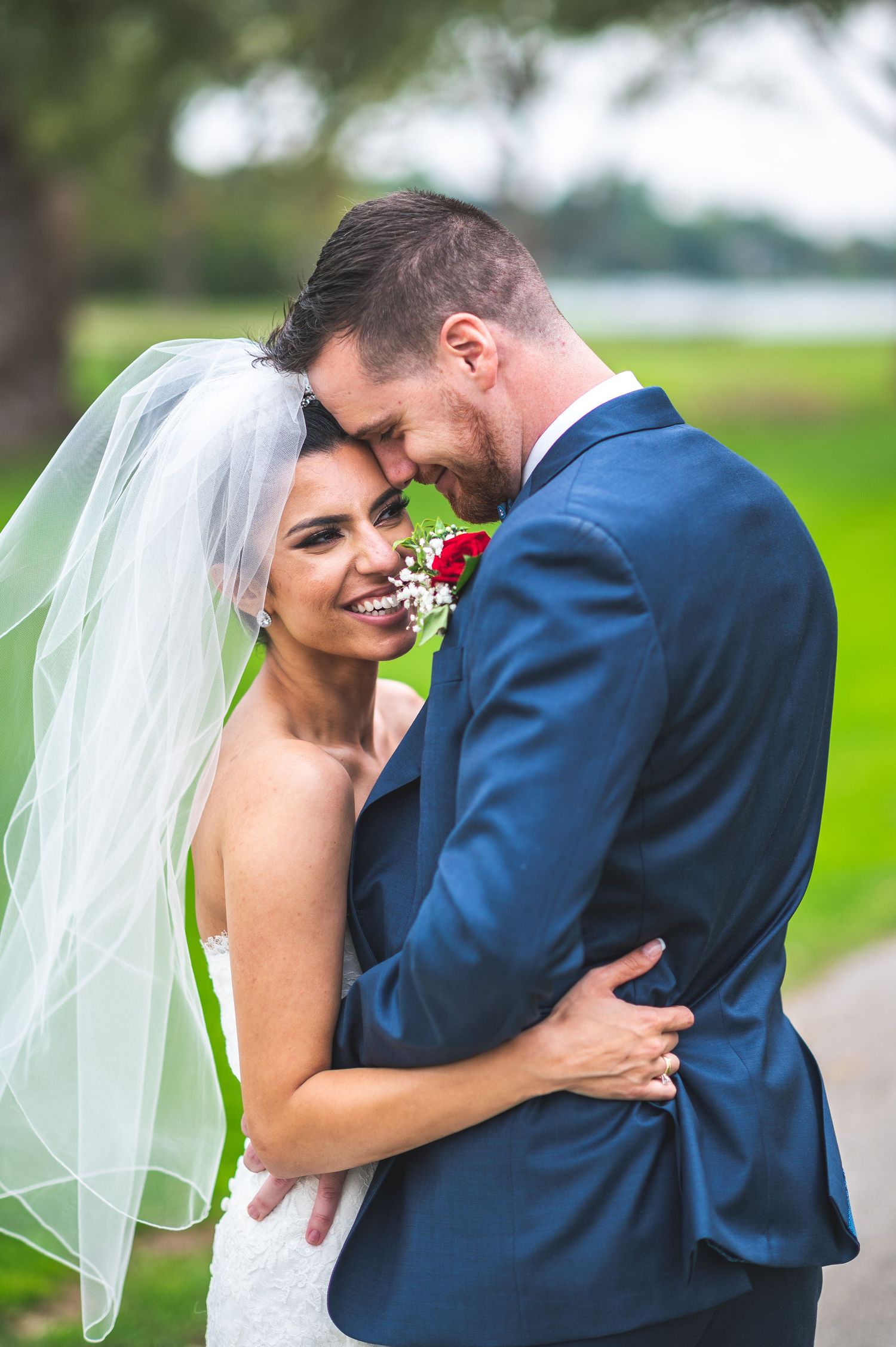 A romantic wedding portrait sequence showing tender moments between newlyweds in a sunlit outdoor setting with white florals.