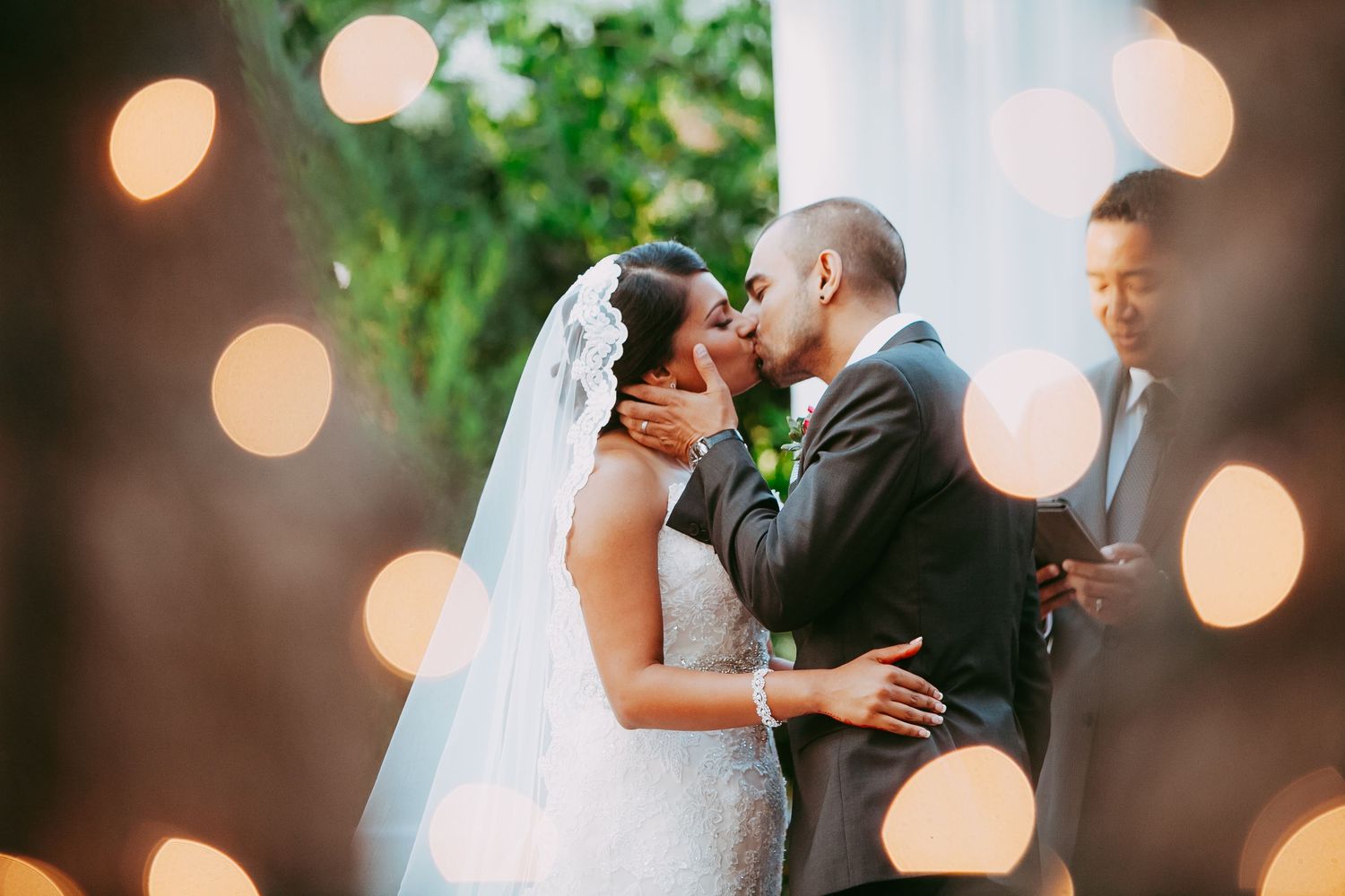 A romantic wedding moment captured with soft bokeh lights creating a dreamy atmosphere during the ceremony.