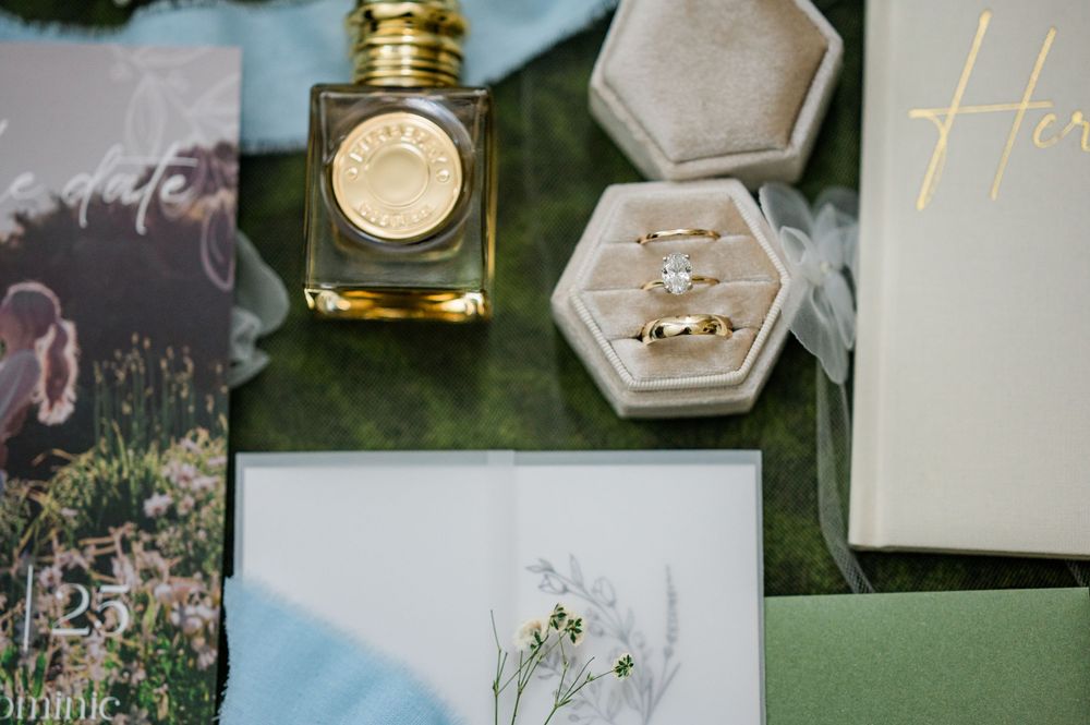 Wedding stationery and invitation details arranged artistically on a dark surface.