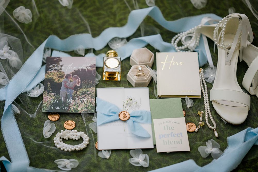 Wedding reception details with vintage-style decorations and handwritten cards on a grassy surface.
