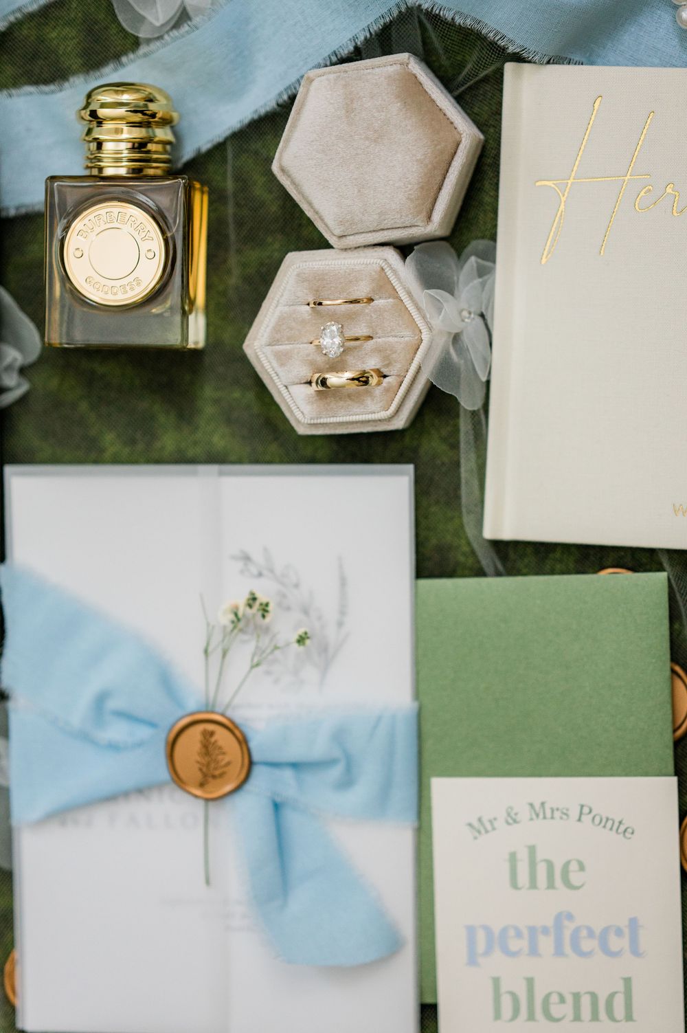 Wedding stationery suite with blue ribbon and gold accents featuring 'The Perfect Blend' text.
