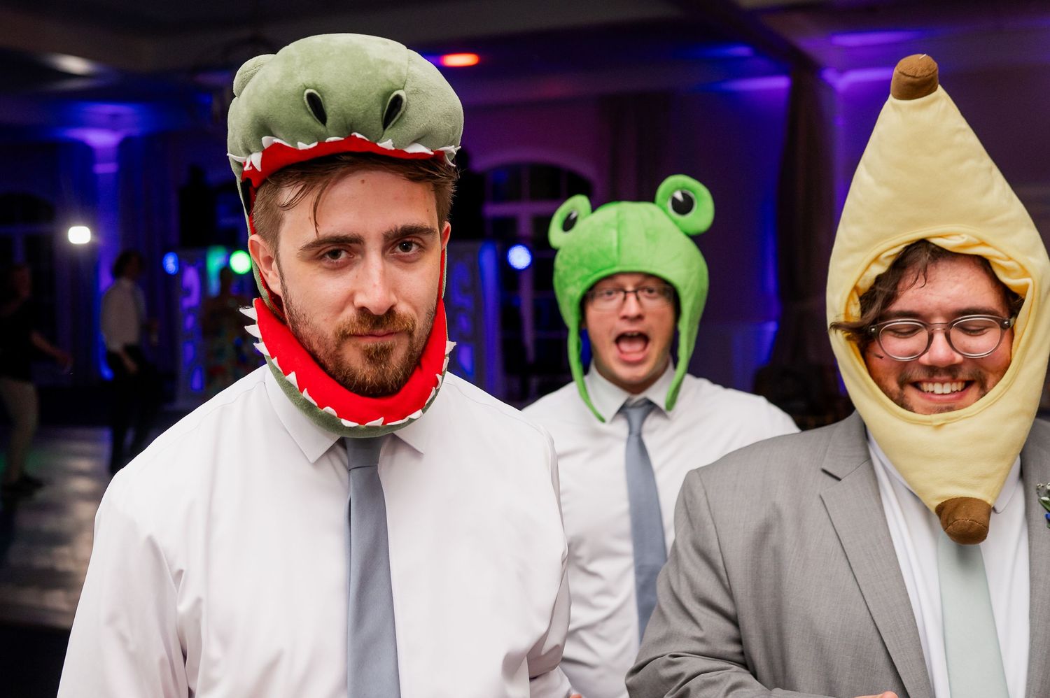 Wedding guests wearing playful animal-themed party hats during reception celebrations.