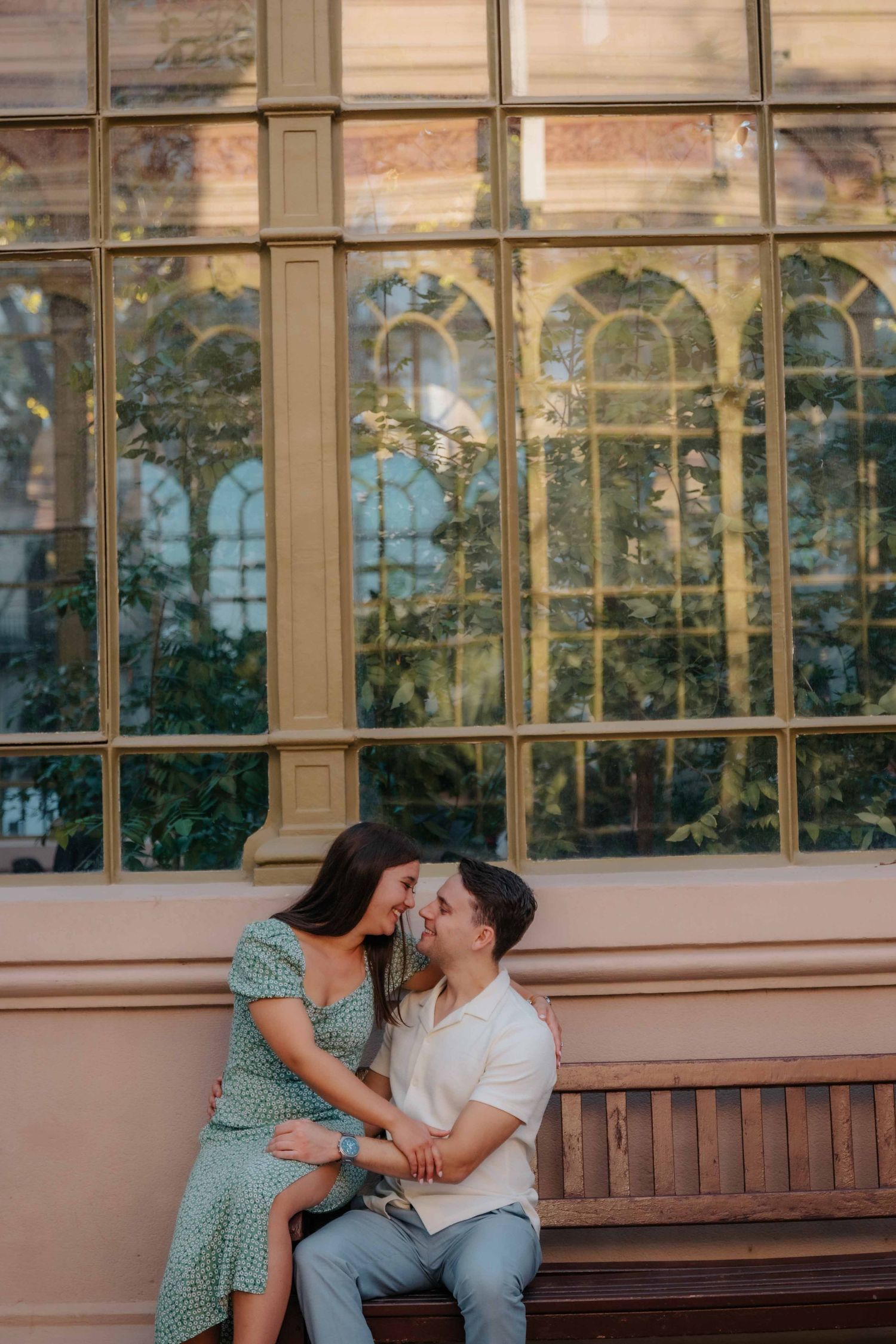 Tender kiss on the forehead in the middle of Barcelona park.