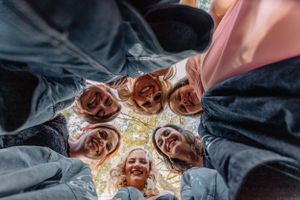 Looking down at a group photo with a unique perspective on an outdoor lawn.