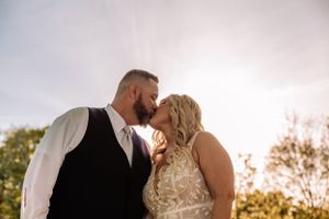 Tender embrace captured during golden hour in a natural outdoor setting.
