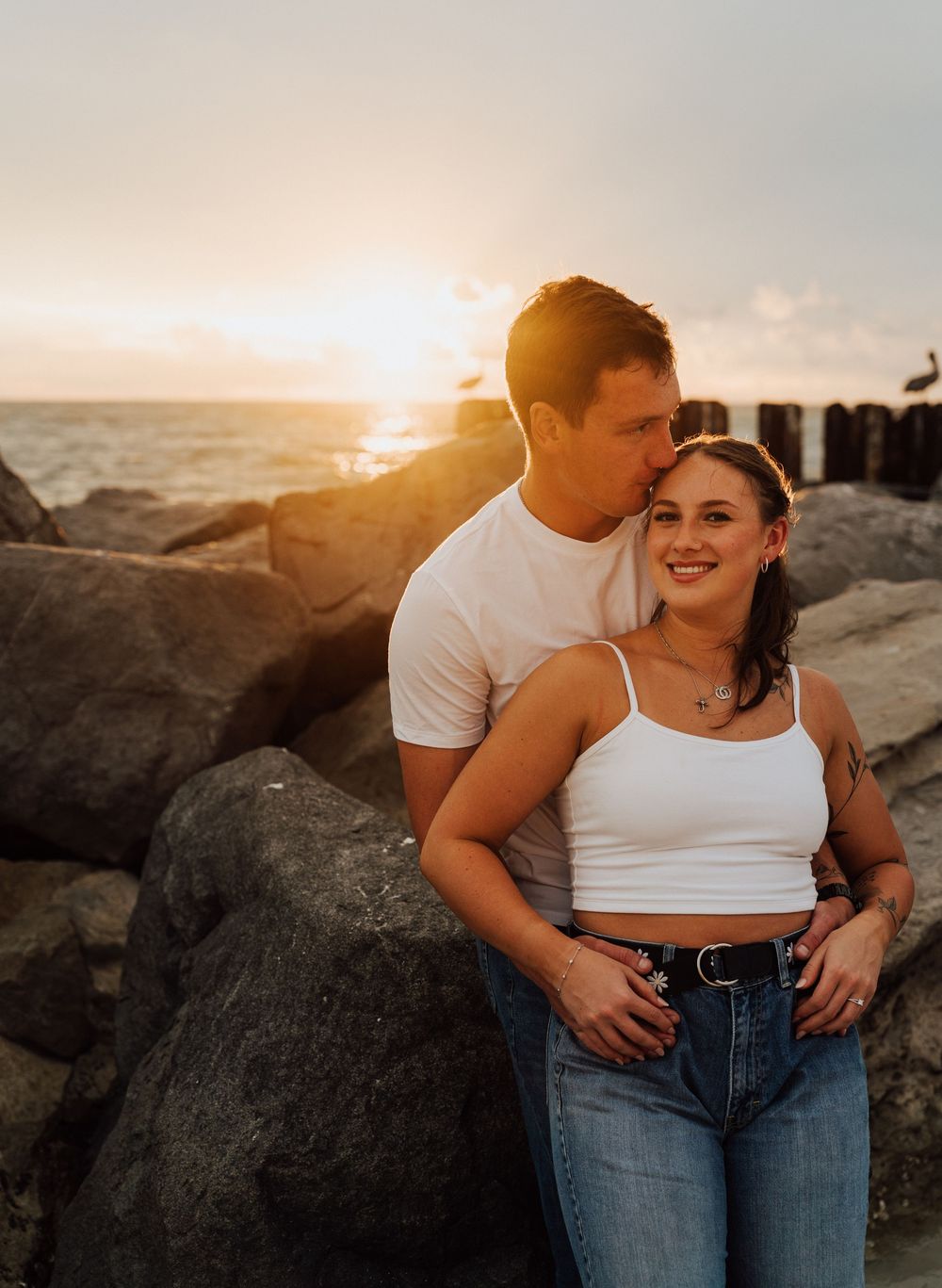 Engagement photoshoot on St. Pete Beach with a coastal sunset as the background. Romantic Tampa Bay coastal vibes.