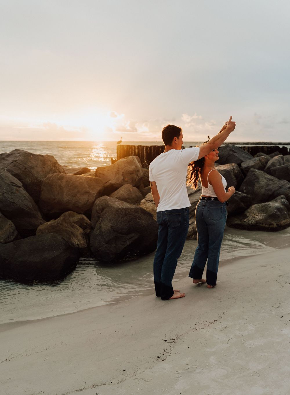 Engagement photoshoot on St. Pete Beach with a coastal sunset as the background. Romantic Tampa Bay coastal vibes.